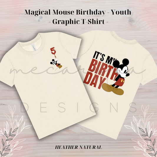 Two heather natural youth t-shirts featuring a Magical Mouse birthday design; one shirt with a mouse holding a number balloon, and the other with the mouse and the text "It's My Birthday."